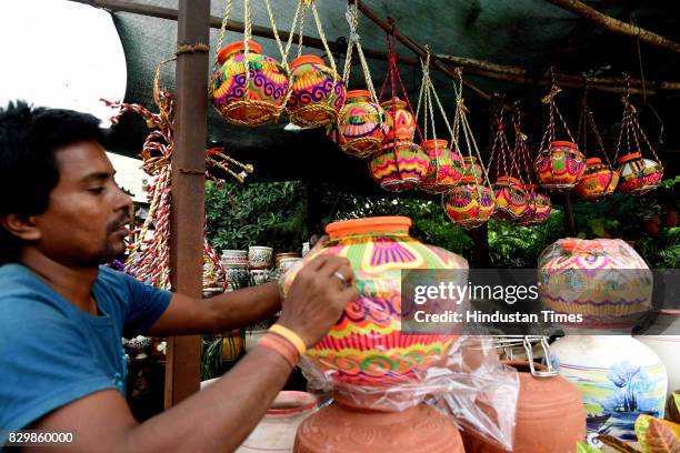 An artist checks a decorative earthern pots ahead of Dahi Handi Festival at Vashi, on August 10, 2017 in Mumbai, India. Dahi Handi is one of the...