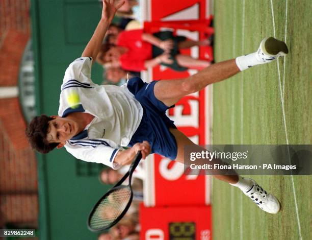 Britain's No.1 Tim Henman makes a return from Javier Frana during today's centre court match in the Stella Artois Grass Court Championships at The...