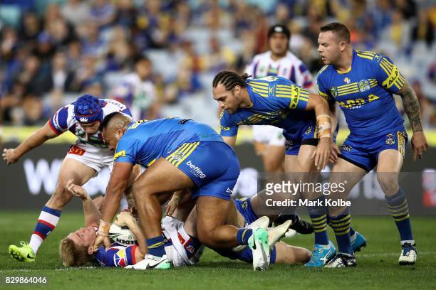 Josh King of the Knights is tackled during the round 23 NRL match between the Parramatta Eels and the Newcastle Knights at ANZ Stadium on August 11,...