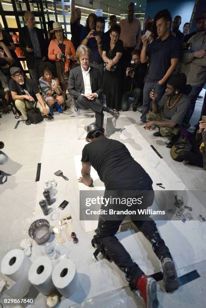 Los Angeles based artist Robert Vargas hand paints actor William H. Macy during a live exhibition at his solo art show at the Sur le Mur Gallery in...