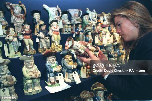 Victoria Coode, of Christie's, examines one of more than 200 Toby jugs from the Bute Collection, which form part of a sale of works of art from the...