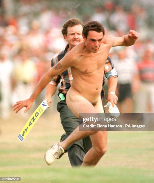 Streaker is pursued by a steward up the 18th fairway during the final hole between Tom Lehman and Nick Faldo to decide the eventual winner of the...