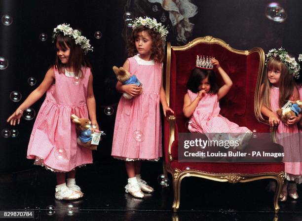 Surrounded by her unidentified assistants, Olivia Al-Adwani the winner of last year's Miss Pears competition, holds onto her crown before giving it...