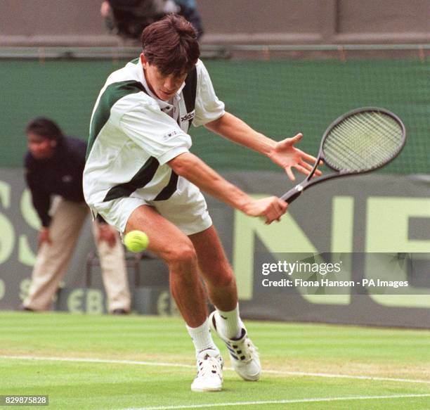 Britain's Tim Henman on his way to a 6-0 6-4 7-5 victory over Eygpt's Amr Ghoneim on No 1 Court at Wimbledon this afternoon . Henman's victory gave...
