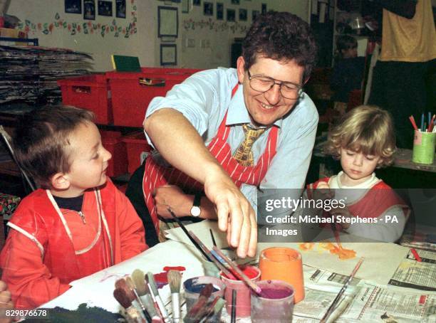 Liberal Democrat Education spokesman Don Foster trying his hand at finger painting with three-year-olds William Carruthers and Rebbeca Long , at the...