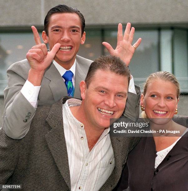 Punter Darren Yates give a piggy back to jockey Frankie Dettori outside the GMTV Studios, London, this morning as his wife, Annaley, looks on. Mr...