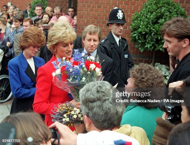 The Princess of Wales receives a bouquet of flowers from wellwishers who had turned out to see her at the London Lighthouse, a residential and...