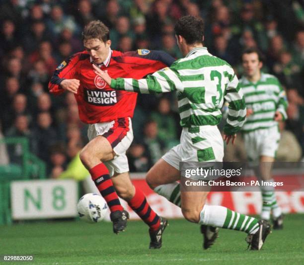 Aberdeen's David Rowson and Brian O'Neil of Celtic battle for the ball during their game at Parkhead today . Photo by Chris Bacon/PA