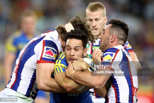 Corey Norman of the Eels is tackled during the round 23 NRL match between the Parramatta Eels and the Newcastle Knights at ANZ Stadium on August 11,...