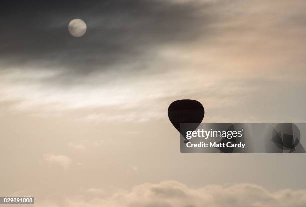 Hot air balloons take to the skies as they participate in the mass assent at sunrise on the second day of the Bristol International Balloon Fiesta on...