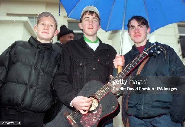 St John's Wood residents Steven Fay Jamie Beattie and Mark Fay prepare to play Oasis songs outside the north west London home of Liam Gallagher and...