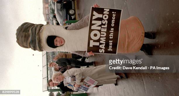 Supporter of Wirral by-election canidate Tony Samuelson demonstrates outside the Asda, Bromborough, this morning where Chancellor Kenneth Clarke was...