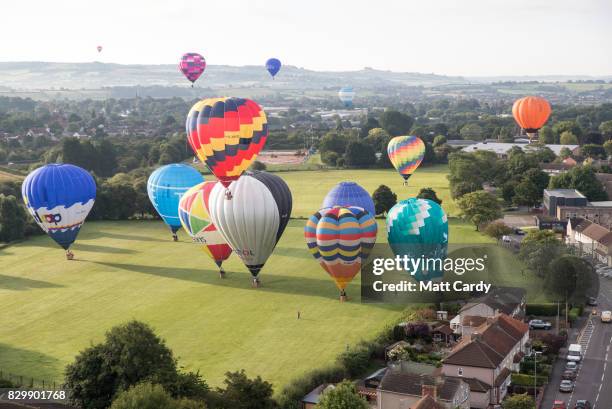 Hot air balloons take to the skies as they participate in the mass assent at sunrise on the second day of the Bristol International Balloon Fiesta on...