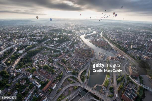 Hot air balloons take to the skies as they participate in the mass assent at sunrise on the second day of the Bristol International Balloon Fiesta on...