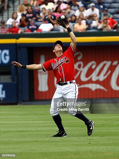 Second baseman Kelly Johnson of the Atlanta Braves drifts back to catch a pop-up during the game against the New York Mets at Turner Field on...