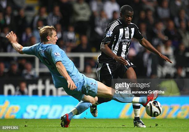 Roman Pavlyuchenko of Tottenham Hotspur stretches to challenge Sebastien Bassong of Newcastle United for the ball during the Carling Cup Third Round...