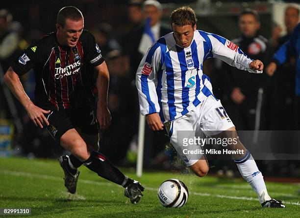 Glenn Murray of Brighton and Hove Albion takes on Richard Dunne of Manchester City during the Carling Cup Second Round match between Brighton and...