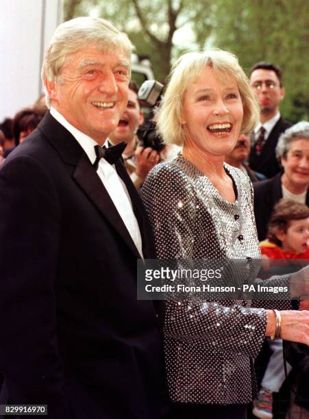Chat show host Michael Parkinson arrives with his wife Mary at the Royal Albert Hall for the BAFTA Award ceremony.