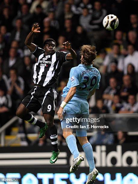 Obafemi Martins of Newscastle United jumps with Jonathan Woodgate of Tottenham Hotspur during the Carling Cup Third Round match between Newcastle...