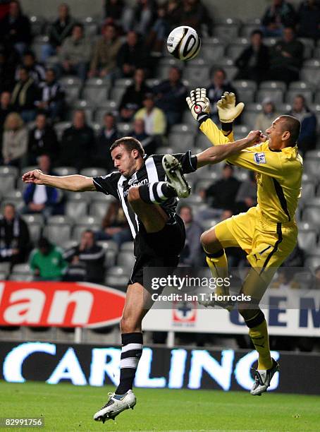 Steven Taylor of Newscastle United jumps with Heurelho Gomes of Tottenham Hotsupr during the Carling Cup Third Round match between Newcastle United...