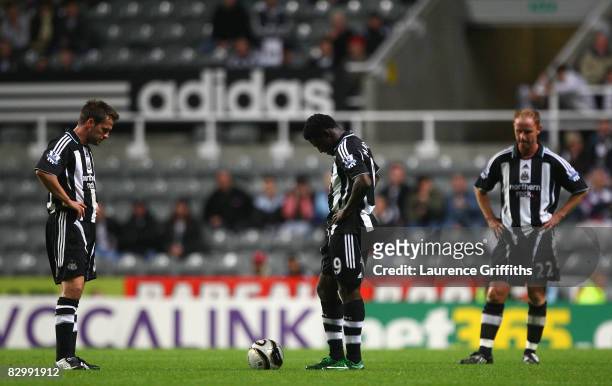 Obafemi Martins and Michael Owen of Newcastle United show their dejection as they prepare to kick off after conceding a second goal during the...