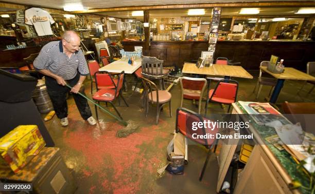 Lawrence Puccetti mops up mud from his restaurant that was damaged from Hurricane Ike September 24, 2008 in Galveston, Texas. City officials are...