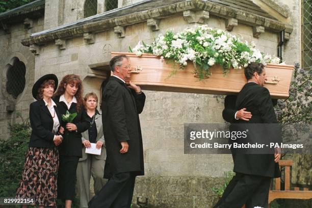 Laurie Lee's coffin is followed by his wife Cathy and daughter Jessye at the funeral service in Slad, Gloucestershire today . See PA Story...