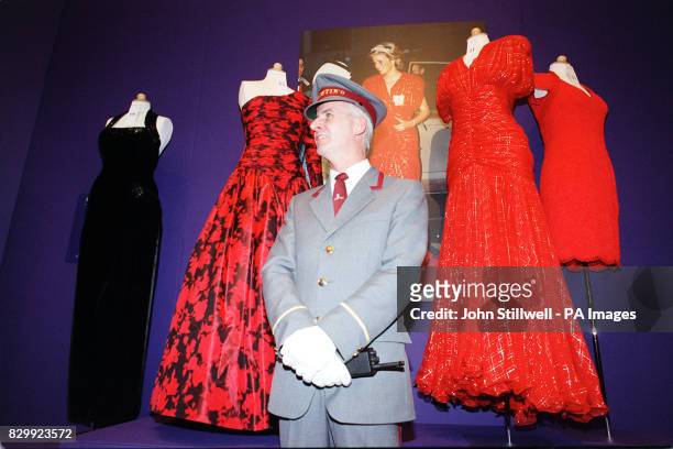 Christie's security guard, Des Murphy, keeps an eye on some of the 79 dresses from the collection donated by Diana, Princess of Wales to the...