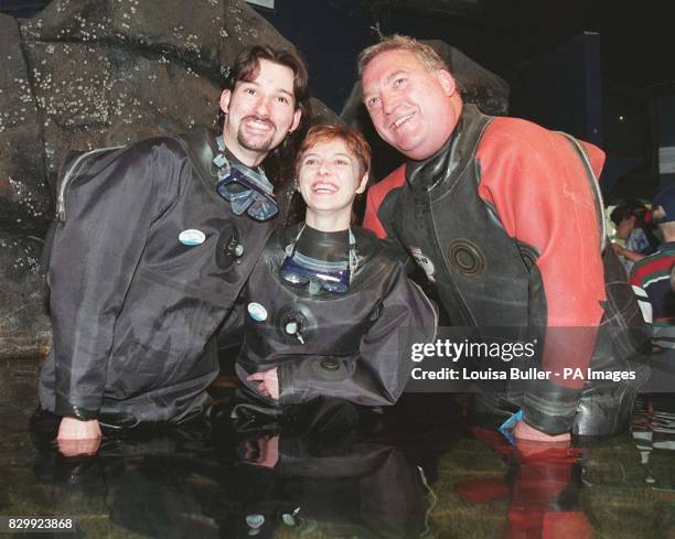 Sweethearts, Robert Scotland, 20 and his fiancee, Morag Shaw with Reverand Richard Russell in the Safari Acquarium at 'Deep-Sea World' near Edinburgh...