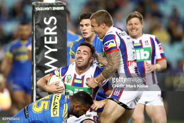 Brock Lamb of the Knights scores a try during the round 23 NRL match between the Parramatta Eels and the Newcastle Knights at ANZ Stadium on August...