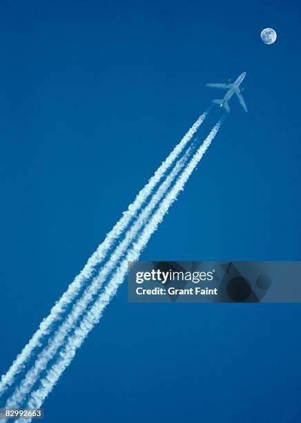 passenger jet flying with moonrise - moon sky and plane stock pictures, royalty-free photos & images