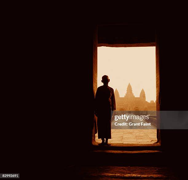 female monk standing in doorway of temple - cambodia fotografías e imágenes de stock