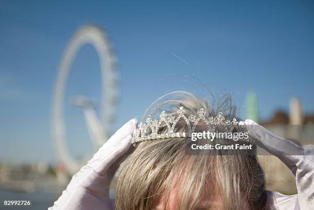 woman playing princess before london eye - woman tiara stock pictures, royalty-free photos & images