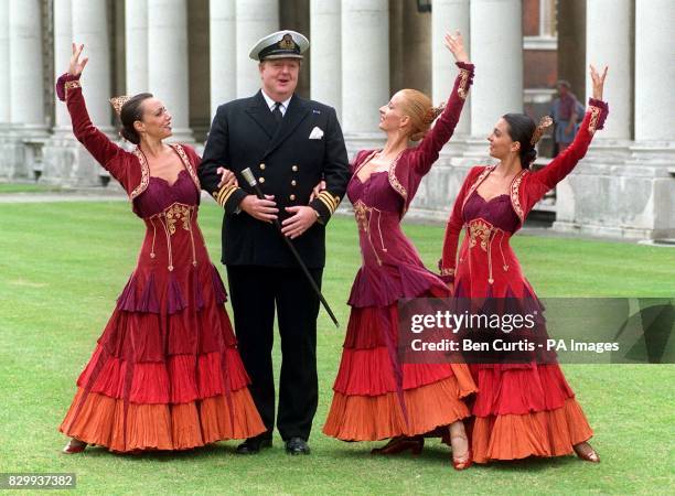 Commander Jonathan Maughan of the Royal Naval College, Greenwich, greets flamenco dancers in the institute's grounds this morning as the college...