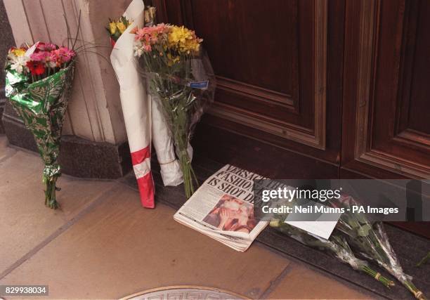 Floral tributes are placed outside the main entrance of Gianni Versace's London shop this evening after news of his death spread across the capital....