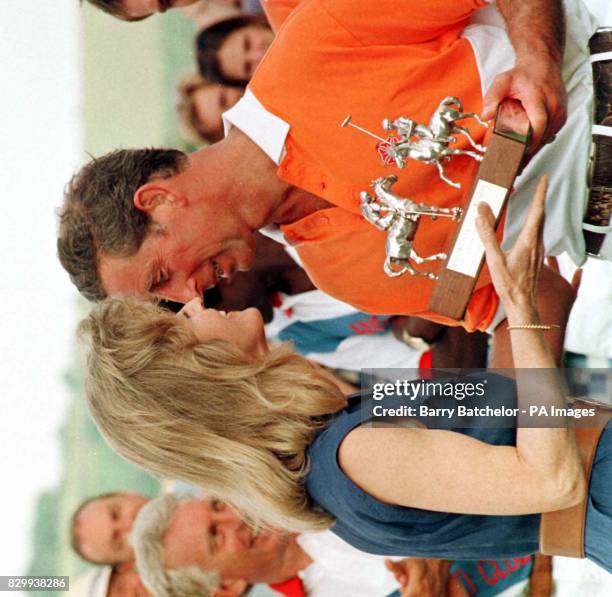 The Prince of Wales kisses Lady Romsey at the presentation ceremony after his team Emlor beat Ansty Polo Club in the Mountbatten Trophy at Ansty Polo...