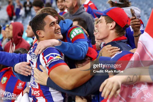 Sione Mata'utia of the Knights celebrates victory with the crowd during the round 23 NRL match between the Parramatta Eels and the Newcastle Knights...
