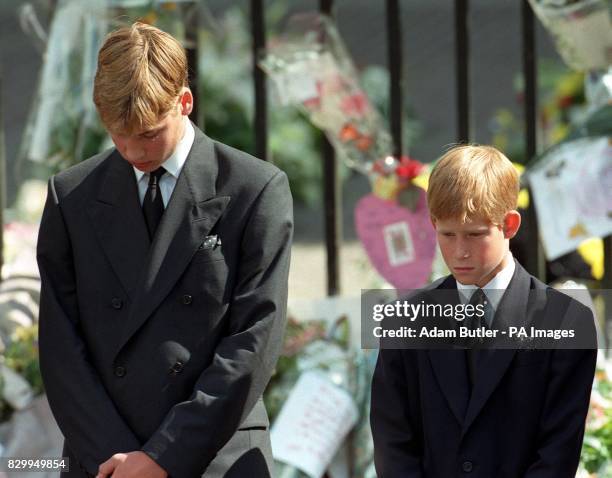 Prince William and Prince Harry, the sons of Diana, Princess of Wales, bow their heads as their mother's coffin is taken out of Westminster Abbey...