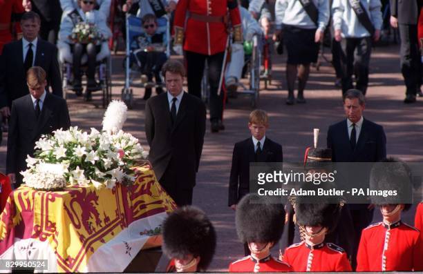 The sons of Diana, Princess of Wales, her brother and her former husband, the Prince of Wales, somberly walk behind her coffin as the funeral...