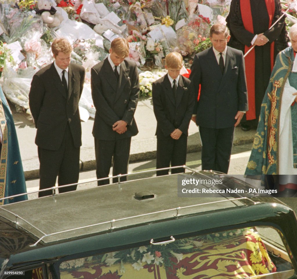 Prince William and Prince Harry give their mother, Diana the Princess of Wales a last look as her coffin is placed in the hearse which will carry her to her final resting place on the Althorp Estate. (Photo by Rebecca Naden - PA Images/PA Images via Getty Images)