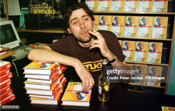 Comedian Sean Hughes takes a break from signing his debut novel 'The Retainers' and enjoys a cigarette in Books Etc in London.