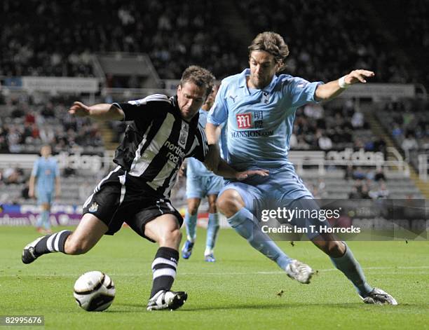 Michael Owen of Newcastle United is challenged by Jonathan Woodgate of Tottenham Hotspur during the Carling Cup Third Round match between Newcastle...