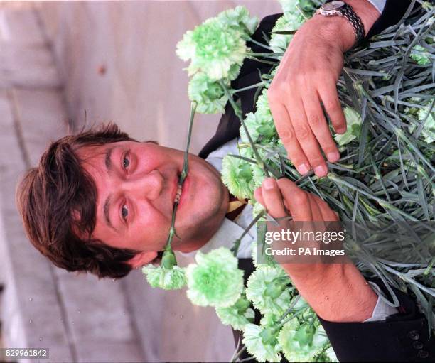 Actor Stephen Fry covers himself in green carnations, as he launches 'A Wilde week in Jermyn Street', celebrating the life and times of Oscar Wilde,...