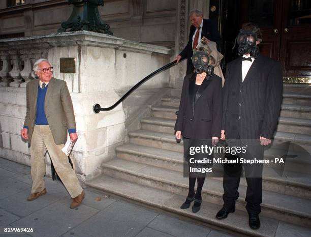 Croupier staff in gas masks protest outside the British Casino Association at the Reform Club in London's Pall Mall today to warn their employers...