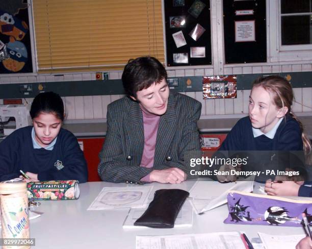 Schools Minister Estelle Morris chats to pupils Bismillah Tailor, 12 and Chloe Hurt, 11 during a visit to The Sarah Bonnell School for girls in east...