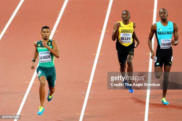 Wayde van Niekerk of South Africa leads Nathon Allen of Jamaica and Steven Gardiner of the Bahamas across the finish line in the Men's 400 metres...