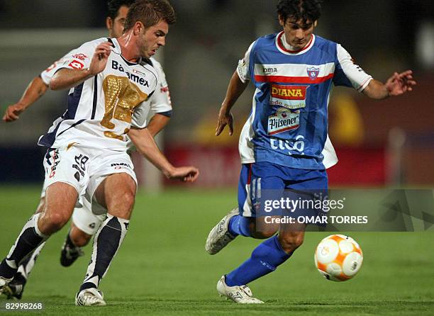 Alex Diego of Pumas vies fhe ball with Fernando Leguizamon of Salvadorean Luis Angel Firpo, during a Concacaf Champions Cup football match on...