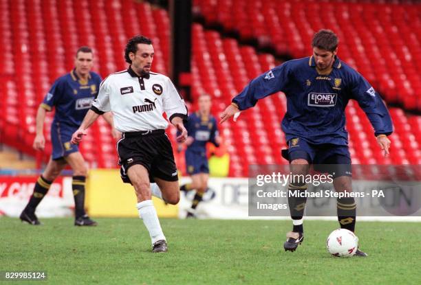 Wimbledon's Alan Kimble screens the ball from Derby County's Francesco Baiano during their FA Carling Premiership match at Selhurst Park today ....