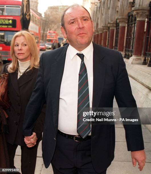 British Airways pilot Christopher Lankey with an unidentified woman outside the High Court this afternoon where he is seeking a declaration against...