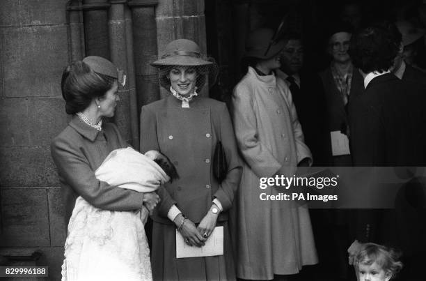 PA NEWS PHOTO 13/3/83 1983: THE PRINCESS OF WALES GLANCES AT HER NEW GOD-DAUGHTER ALEXANDRA VICTORIA EDWINA DIANA IN THE ARMS OF HER MOTHER LADY...